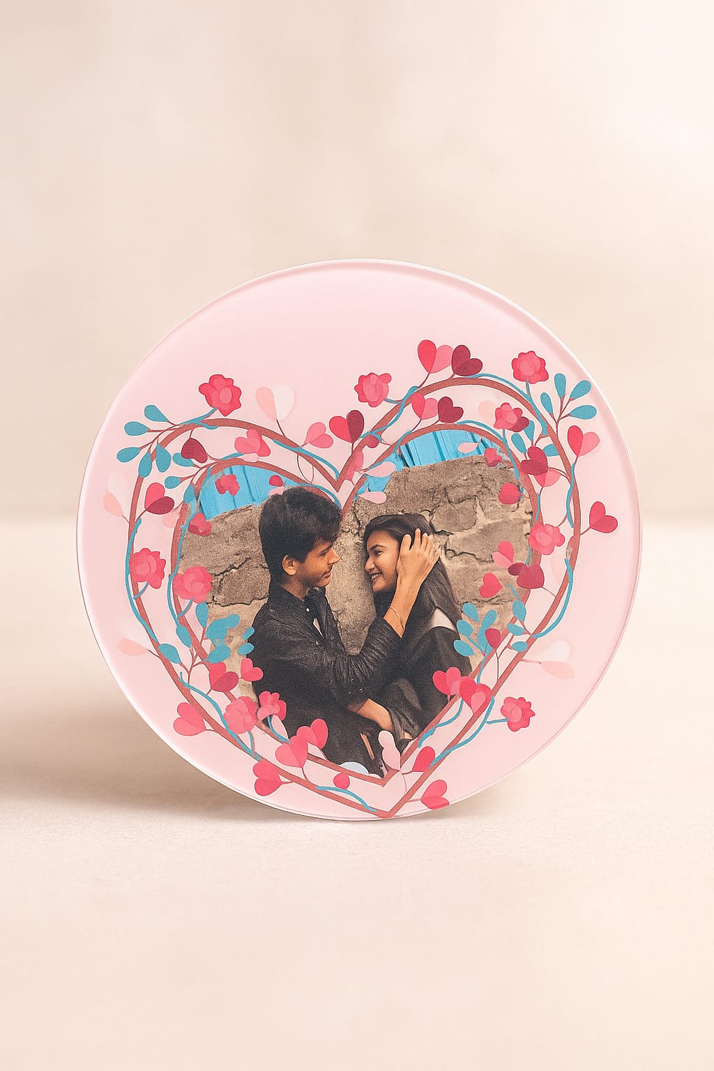 Fridge magnet displaying a couple’s photo with their names printed on a heart-shaped background.