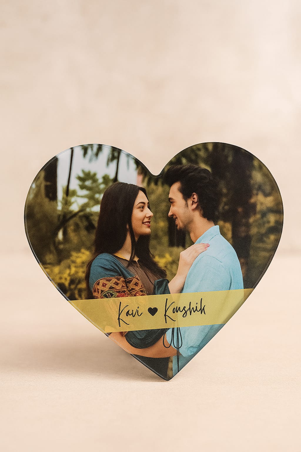 Heart-shaped photo fridge magnet with printed names, customized as a couple keepsake.

